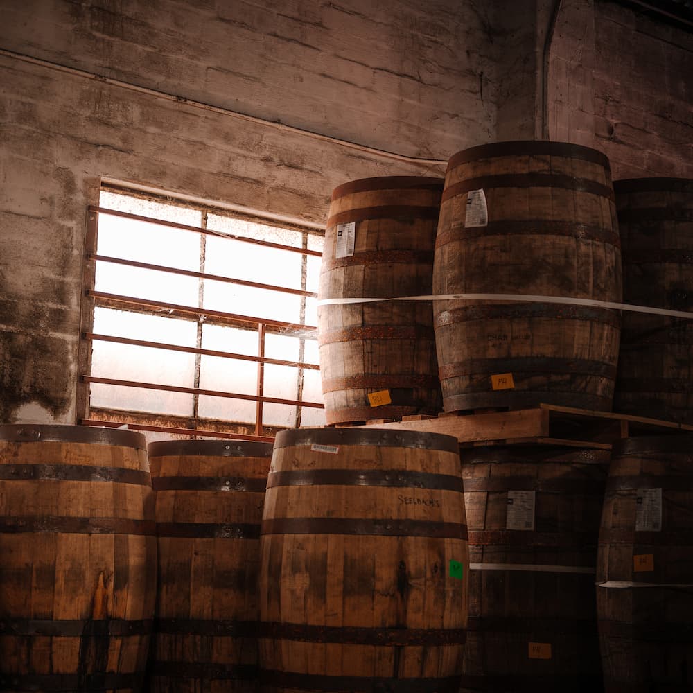Whiskey barrels aging in warehouse